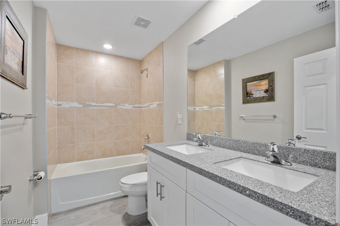 16582 Becasse Drive Punta Gorda, FL 33955 - Photo 19 of 32 a bathroom with a granite countertop sink toilet and shower