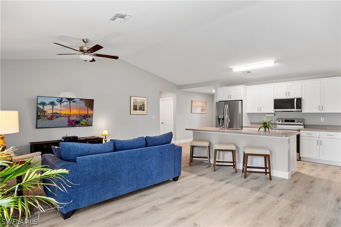 16582 Becasse Drive Punta Gorda, FL 33955 - Photo 6 of 32 a living room with furniture kitchen view and a potted plant