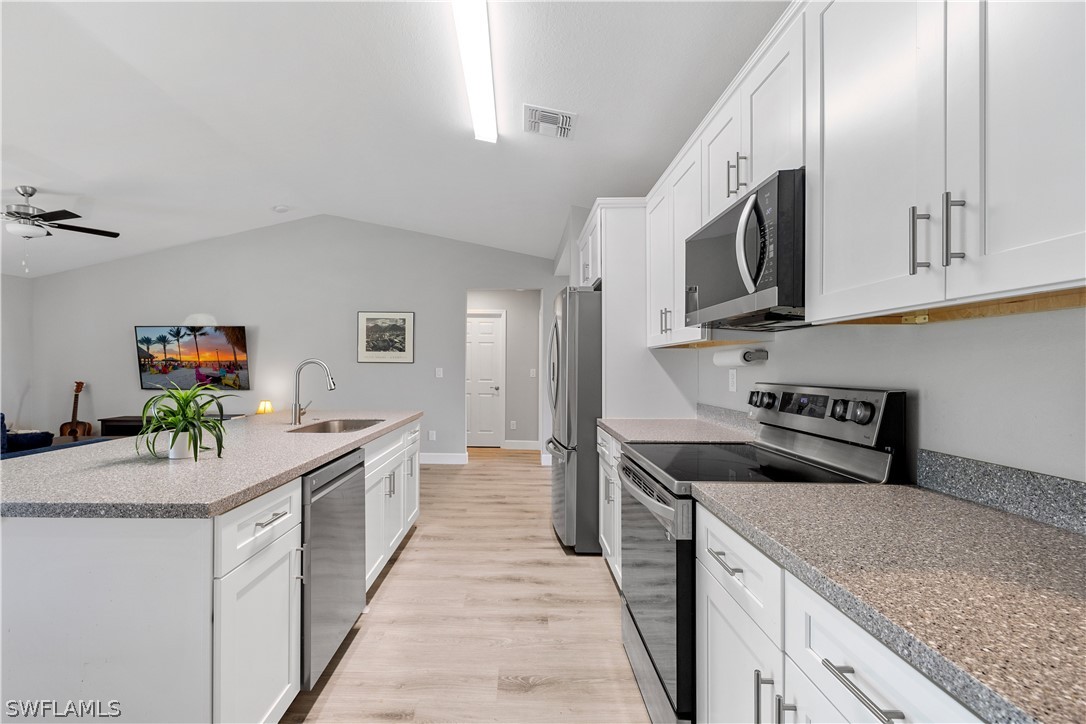 16582 Becasse Drive Punta Gorda, FL 33955 - Photo 9 of 32 a kitchen with stainless steel appliances granite countertop a sink and a stove