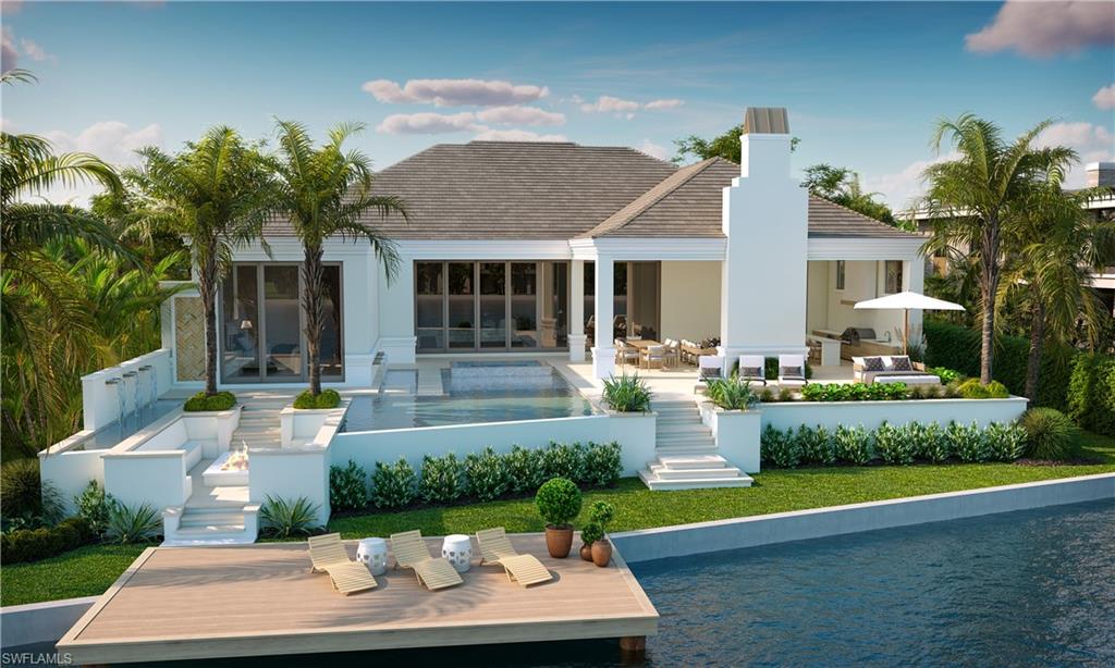 310 Pirates Bight Naples, FL 34103 - Photo 2 of 16 a front view of a house with a garden and plants