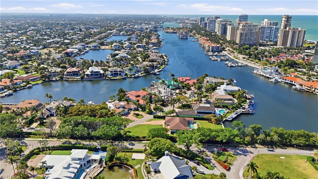 310 Pirates Bight Naples, FL 34103 - Photo 7 of 16 an aerial view of lake and residential houses with outdoor space