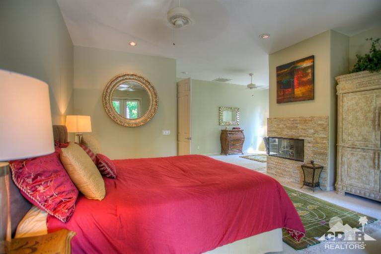 35 Abby Road Rancho Mirage, CA 92270 - Photo 54 of 70 a bedroom with a bed and a fireplace