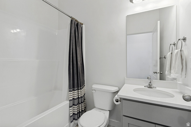 765 Crystal Crk Road American Fork, UT 84003 - Photo 18 of 27 Hall bathroom featuring a built-in soaking tub with shower, single vanity with a white countertop, and a contemporary mirror