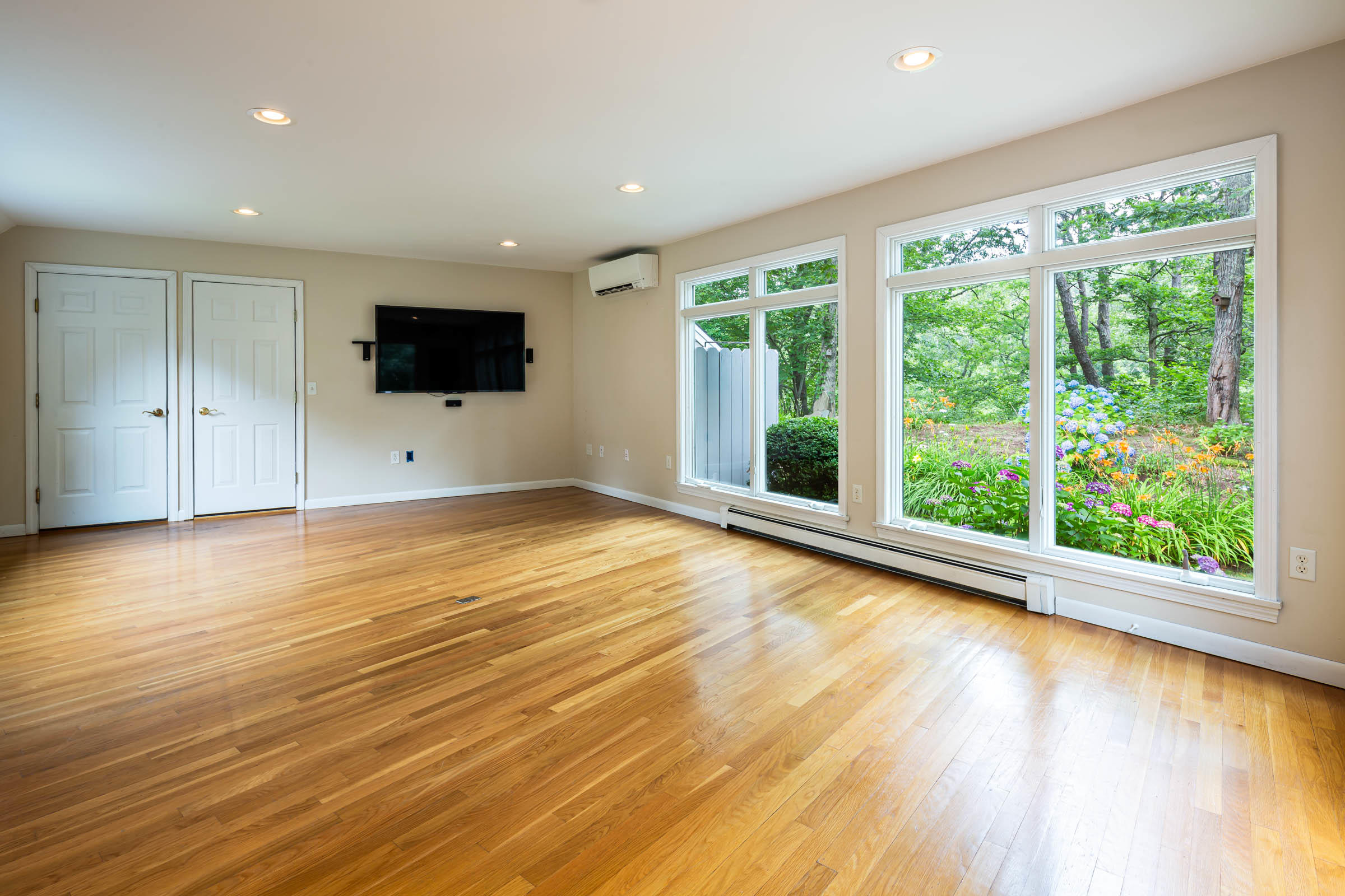 176 Monument Road Orleans, MA 02653 - Photo 11 of 55 a view of a livingroom with wooden floor and a flat screen tv