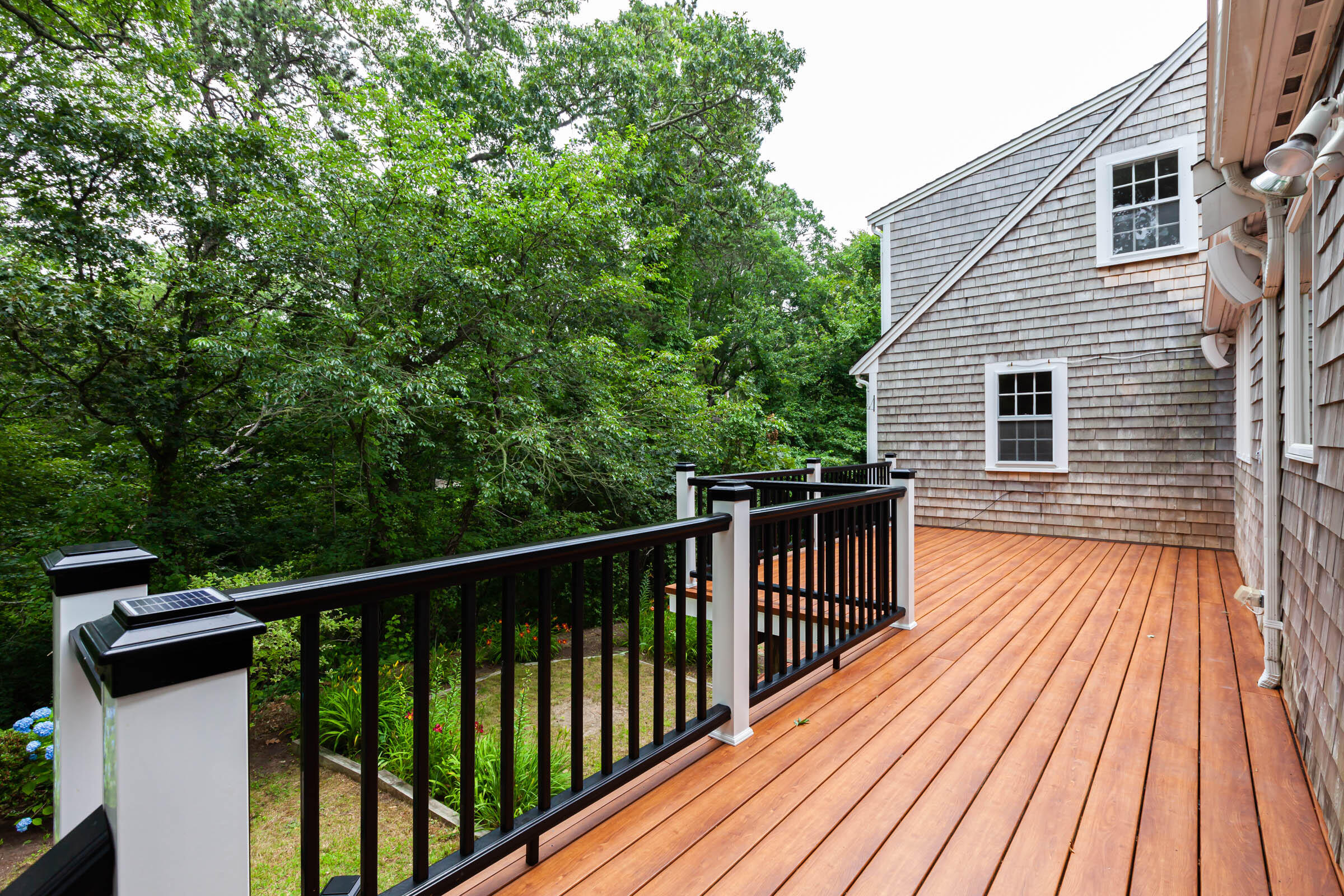 176 Monument Road Orleans, MA 02653 - Photo 13 of 55 a view of a wooden deck with a yard