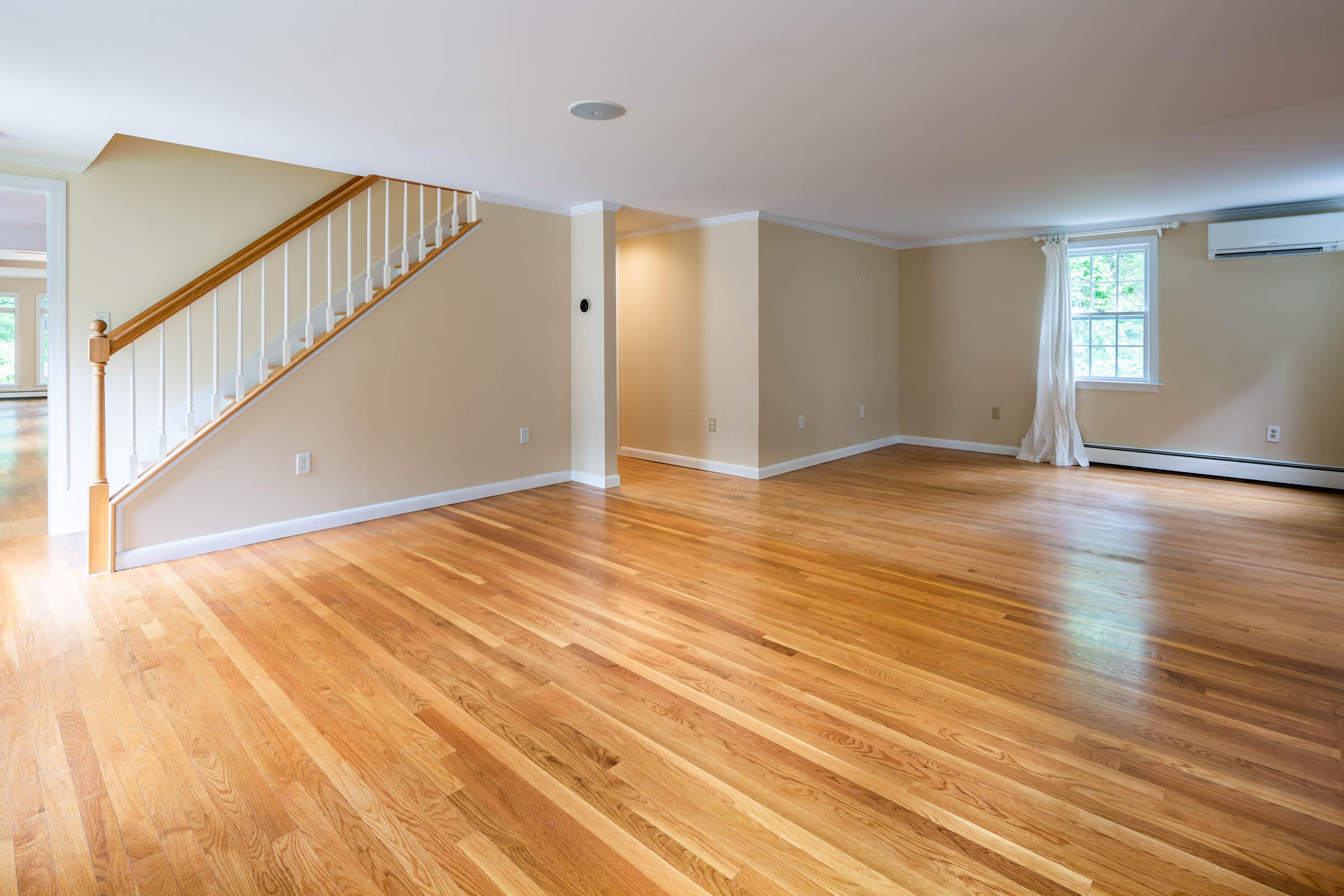 176 Monument Road Orleans, MA 02653 - Photo 17 of 55 a view of an empty room with wooden floor and stairs