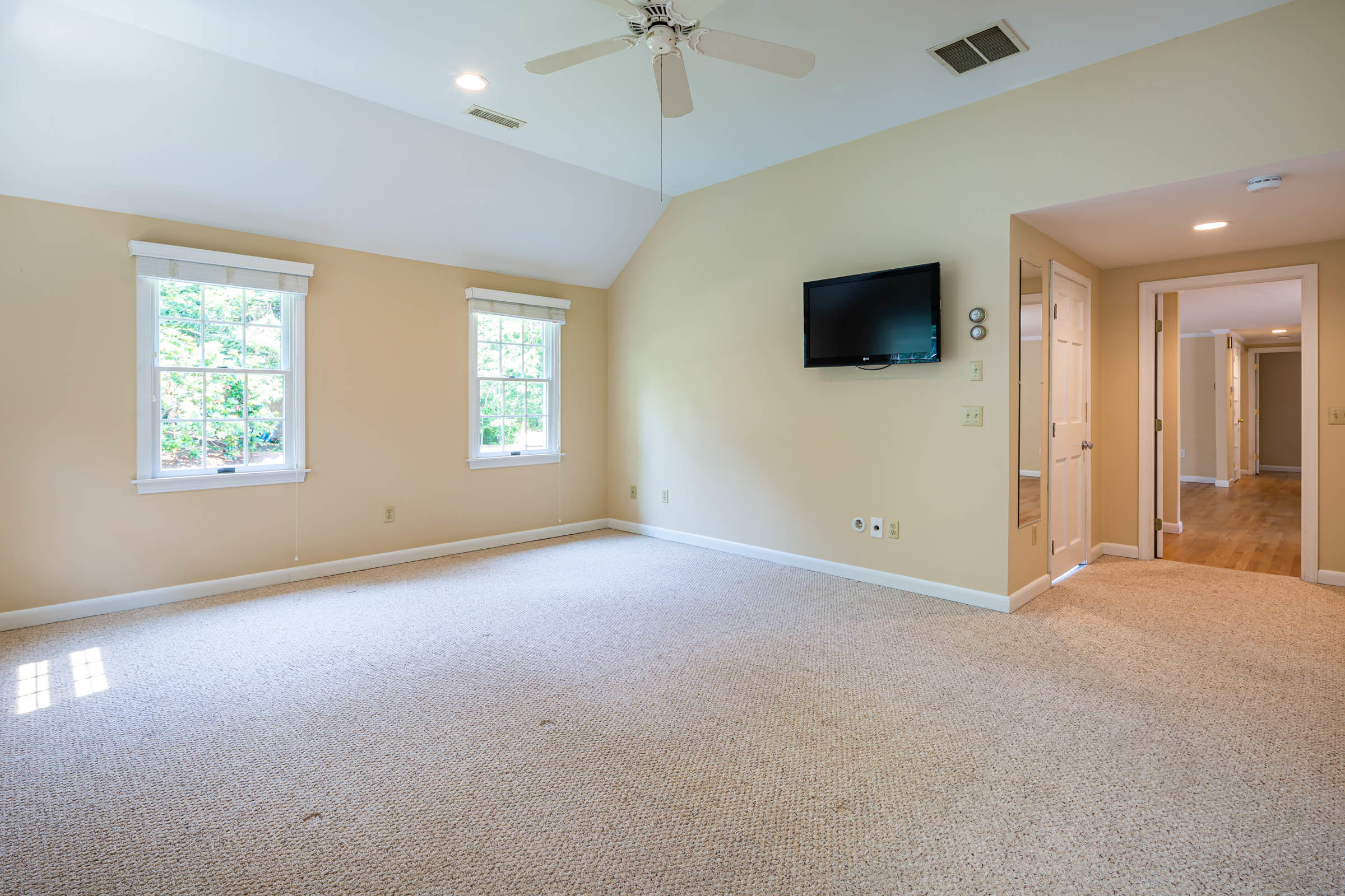 176 Monument Road Orleans, MA 02653 - Photo 26 of 55 an empty room with windows and fireplace