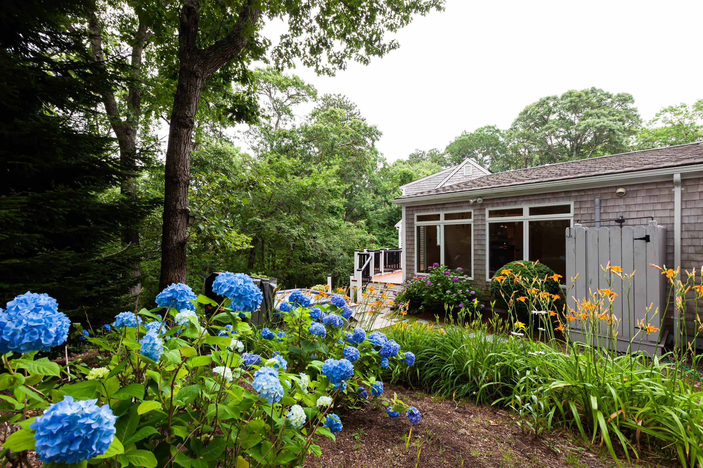 176 Monument Road Orleans, MA 02653 - Photo 52 of 55 a front view of a house with lots of flowers
