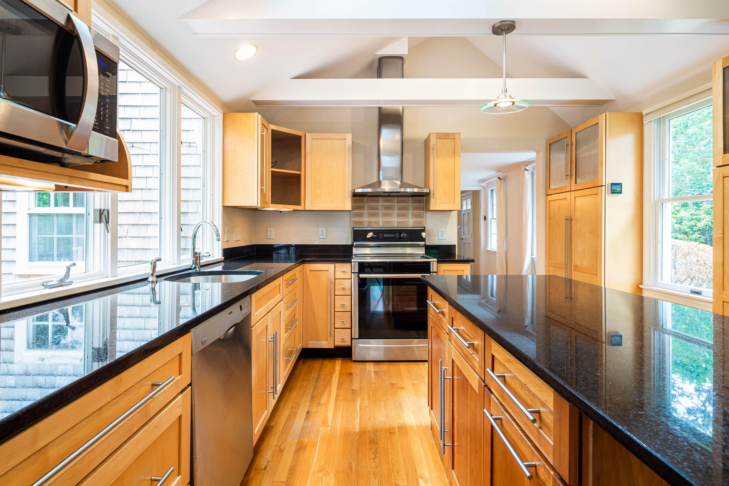 176 Monument Road Orleans, MA 02653 - Photo 6 of 55 a kitchen with stainless steel appliances granite countertop a sink a stove and a wooden floors