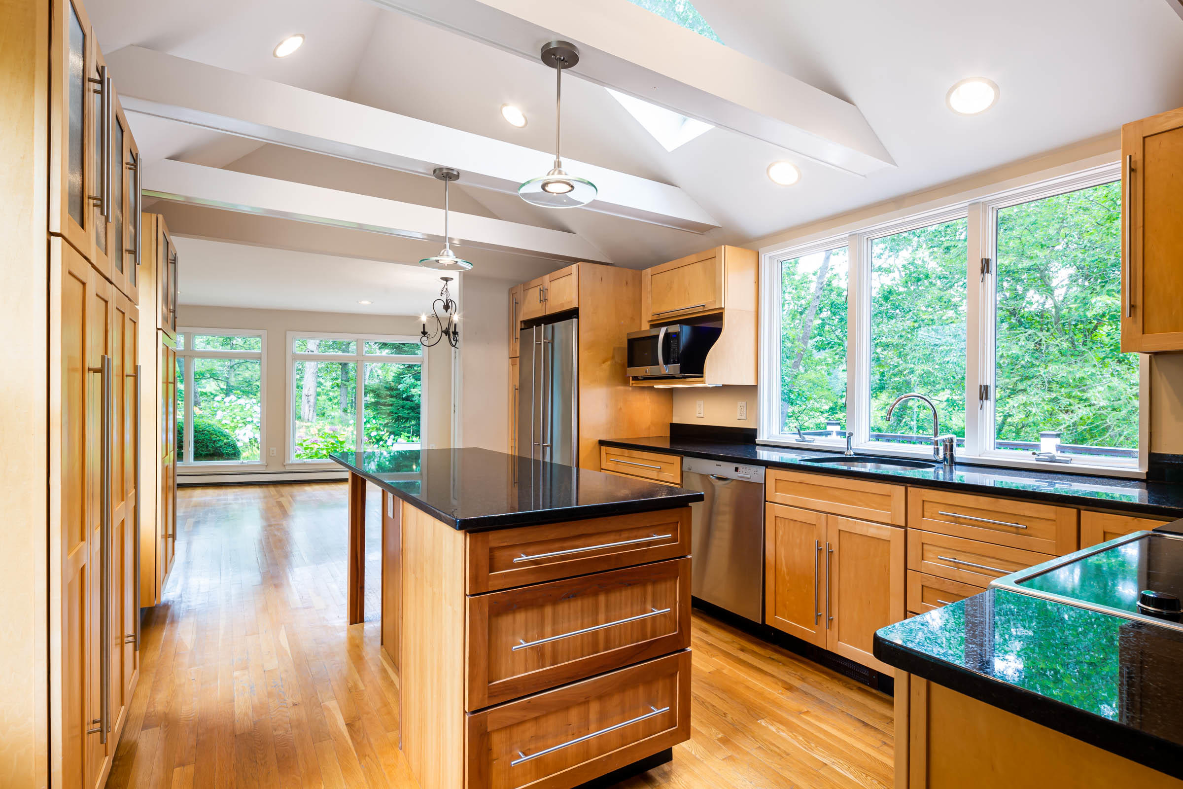176 Monument Road Orleans, MA 02653 - Photo 8 of 55 a kitchen with stainless steel appliances kitchen island a large window in it