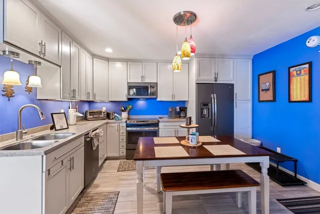 a kitchen with stainless steel appliances a stove refrigerator sink and cabinets