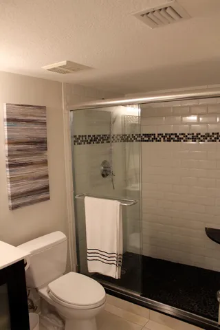 a bathroom with a toilet and a shower