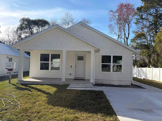 a view of house with backyard space and balcony