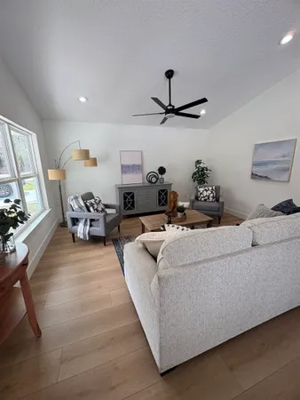 a living room with furniture and wooden floor