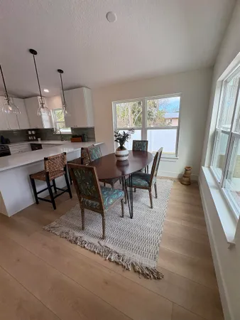 a bedroom with a bed window and a chandelier