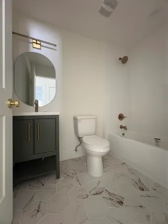 a view of room with wooden floor and ceiling fan