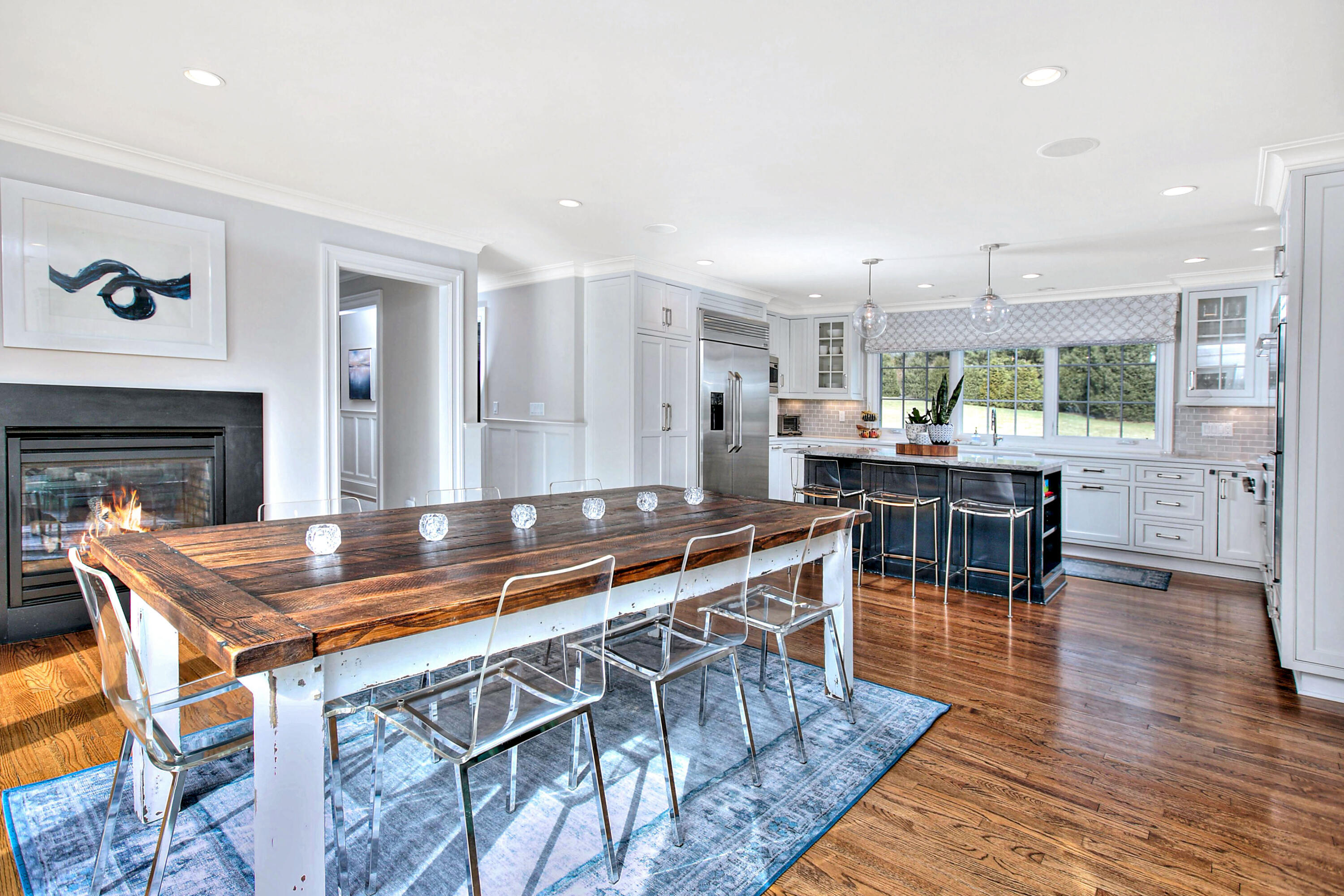 128 Dunning Road New Canaan, CT 06840 - Photo 11 of 49 a kitchen with stainless steel appliances granite countertop a stove a sink and a dining table