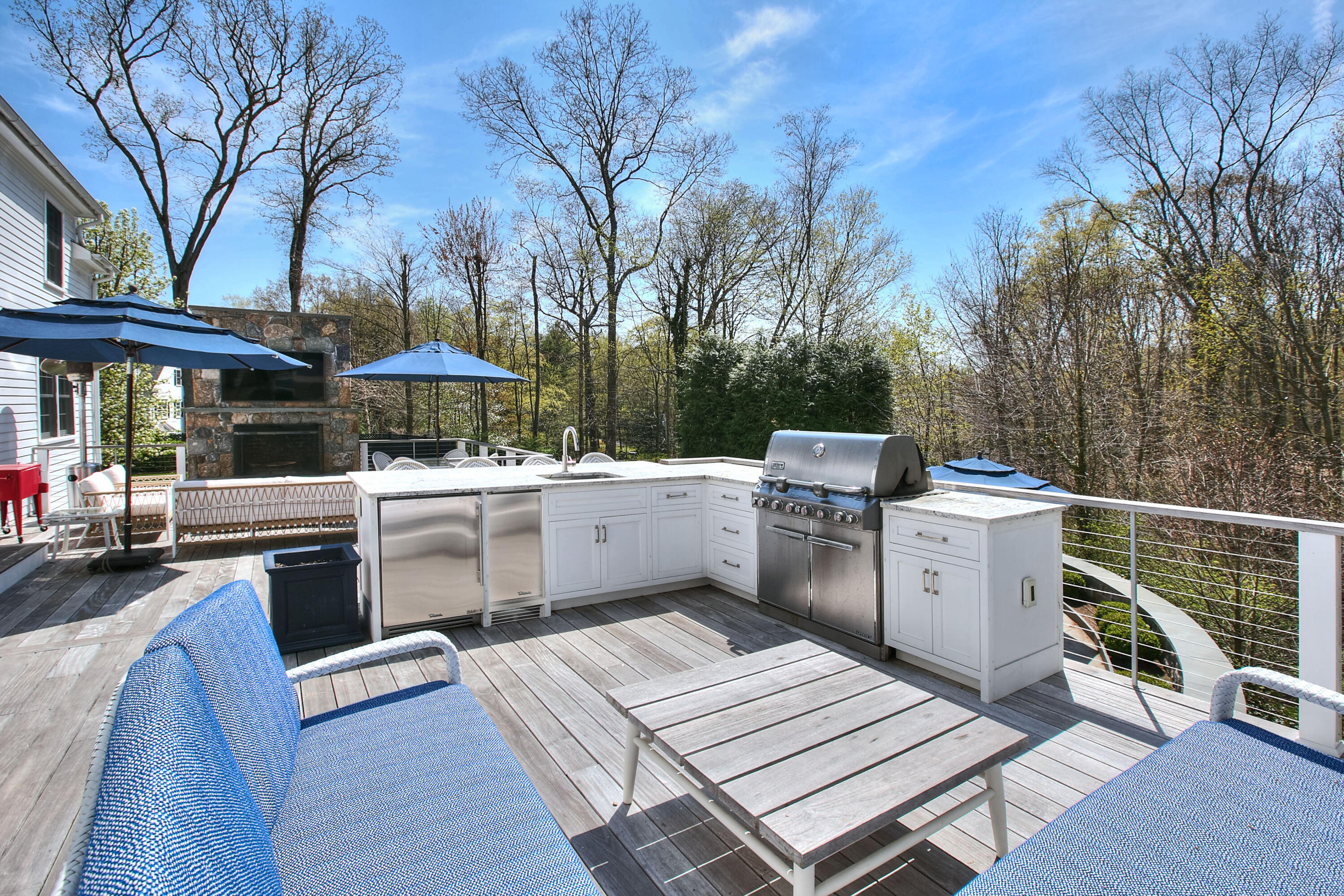 128 Dunning Road New Canaan, CT 06840 - Photo 13 of 49 a view of a chairs and table in the patio and a barbeque