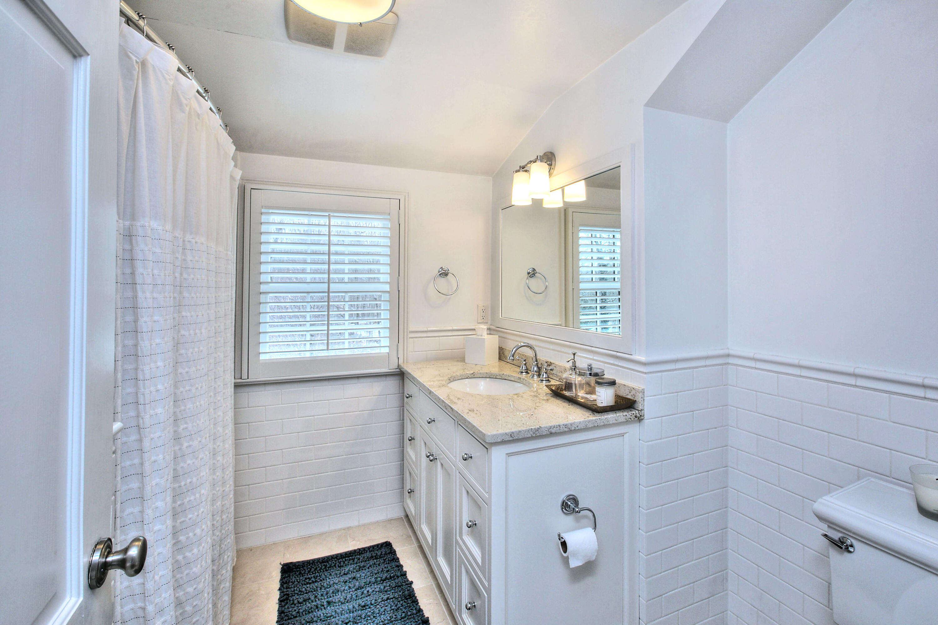 128 Dunning Road New Canaan, CT 06840 - Photo 23 of 49 a bathroom with a granite countertop sink and a mirror