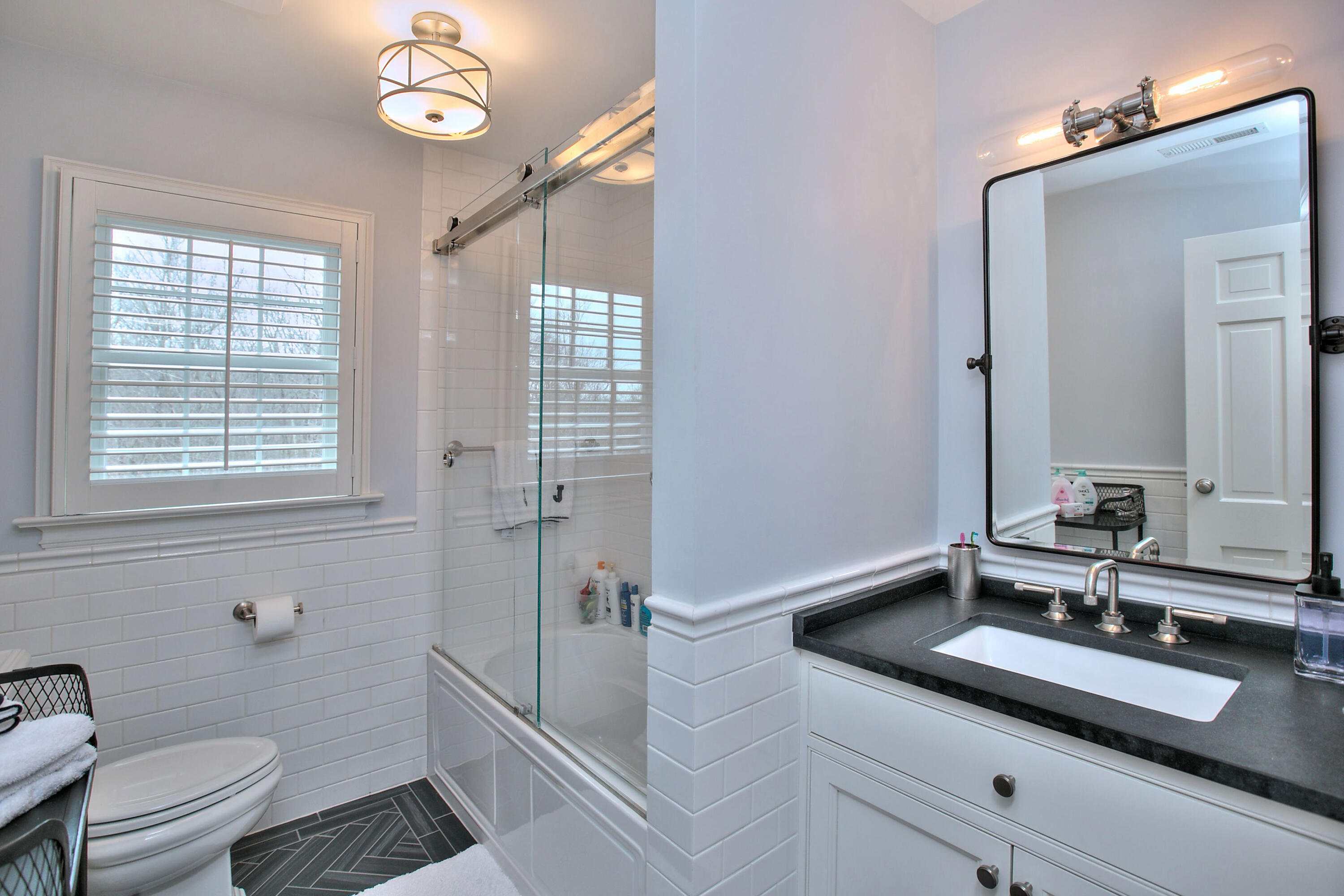 128 Dunning Road New Canaan, CT 06840 - Photo 26 of 49 a bathroom with a sink a toilet a mirror and shower