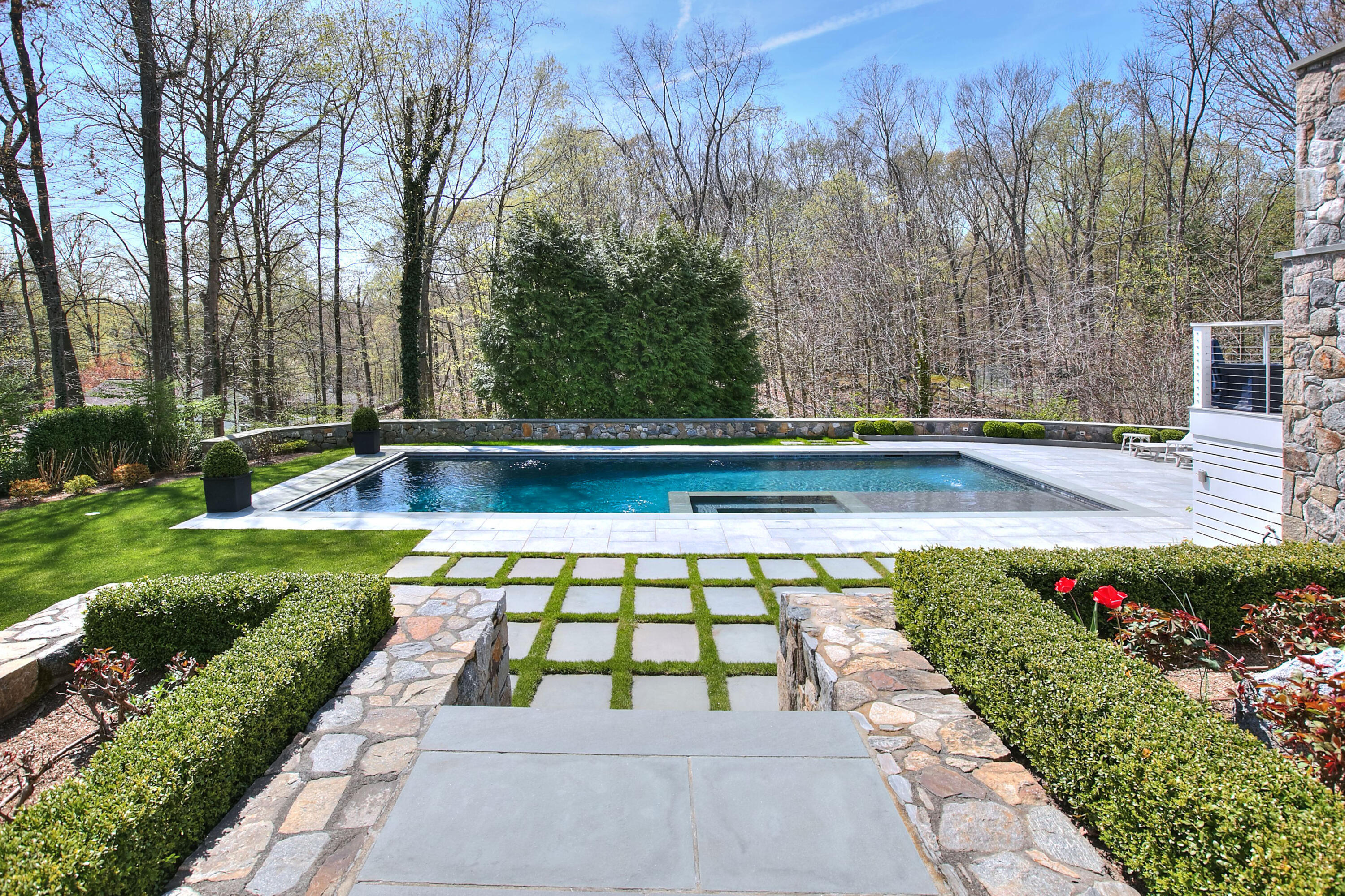 128 Dunning Road New Canaan, CT 06840 - Photo 40 of 49 a view of a backyard with potted plants and large trees