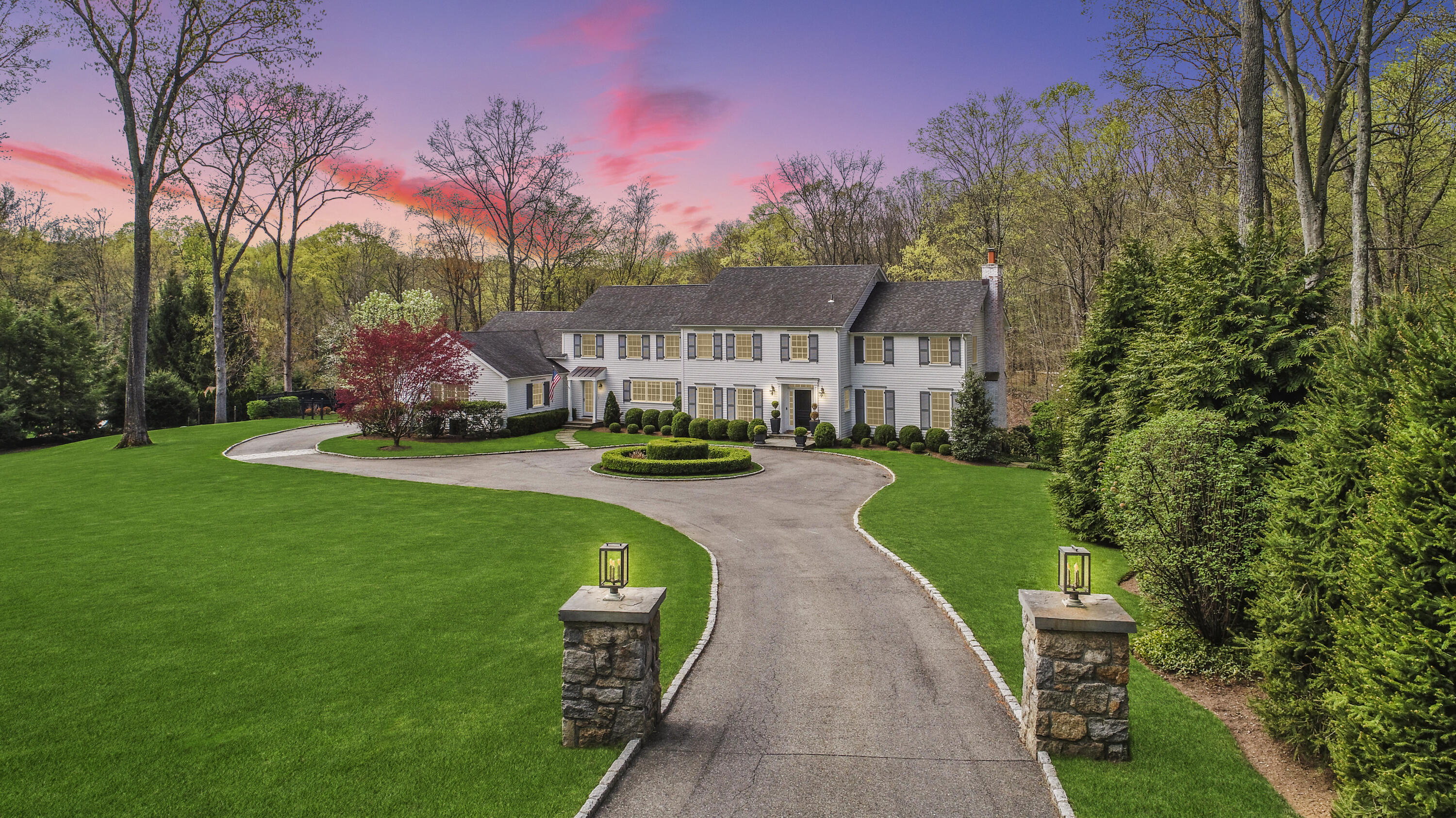 128 Dunning Road New Canaan, CT 06840 - Photo 48 of 49 a front view of a house with a yard and large trees
