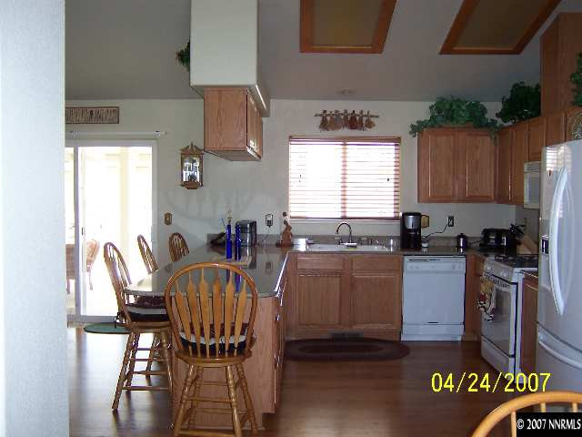 4175 Raven Drive Fallon, NV 89406 - Photo 6 of 9 a kitchen with a table chairs and a refrigerator