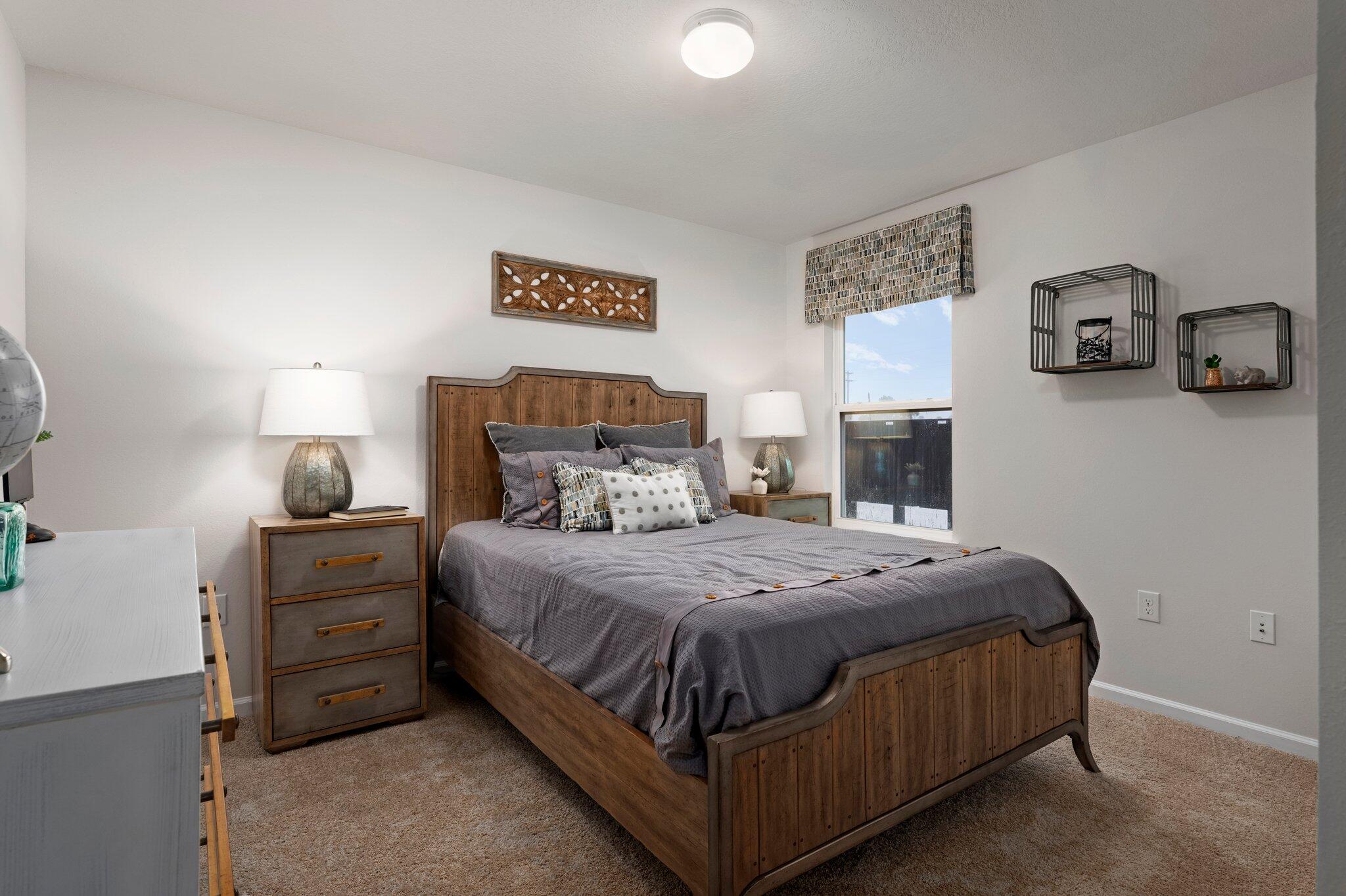 9318 Tara Circle Milton, FL 32583 - Photo 25 of 30 a bedroom with a bed and a tv on the dresser