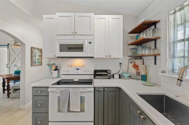 a bedroom with a bed and large windows