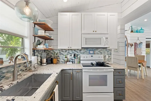 a spacious bedroom with a bed and a flat screen tv