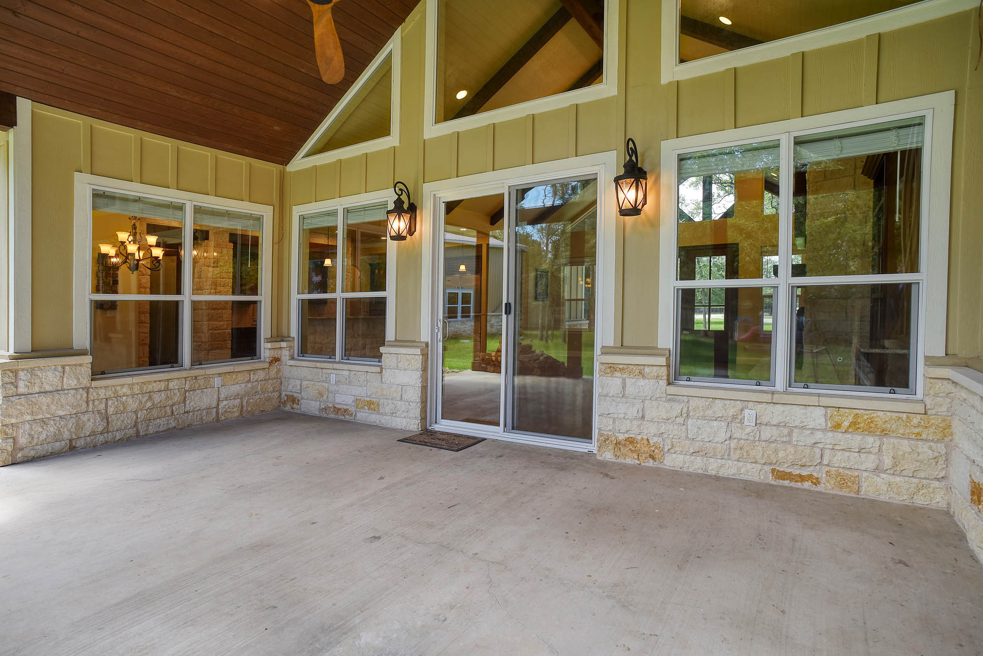 115 Pine Point Cove Elgin, TX 78621 - Photo 32 of 39 A spacious covered patio invites outdoor enjoyment with robust stone accents and ample natural light.
