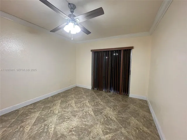 an empty room with closet and a ceiling fan