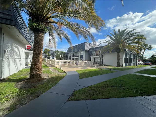 a house view with swimming pool and garden