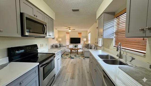 a kitchen with a sink stove and microwave