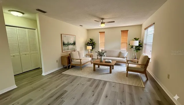 a living room with furniture and a wooden floor