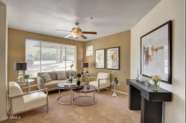 a living room with furniture and a large window