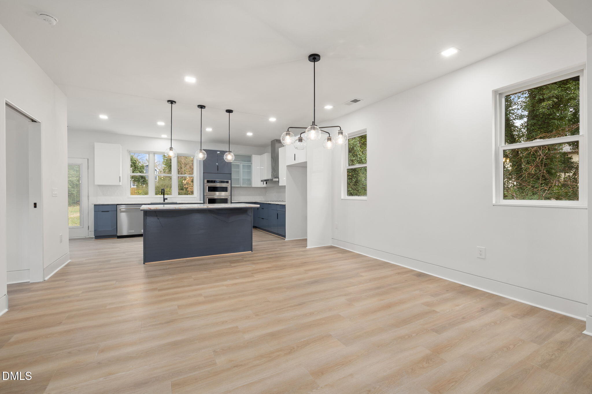 309 Bragg Street Raleigh, NC 27601 - Photo 16 of 55 a view of kitchen with kitchen island white cabinetry and refrigerator