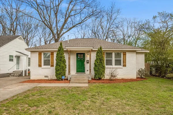 a front view of house with yard and green space