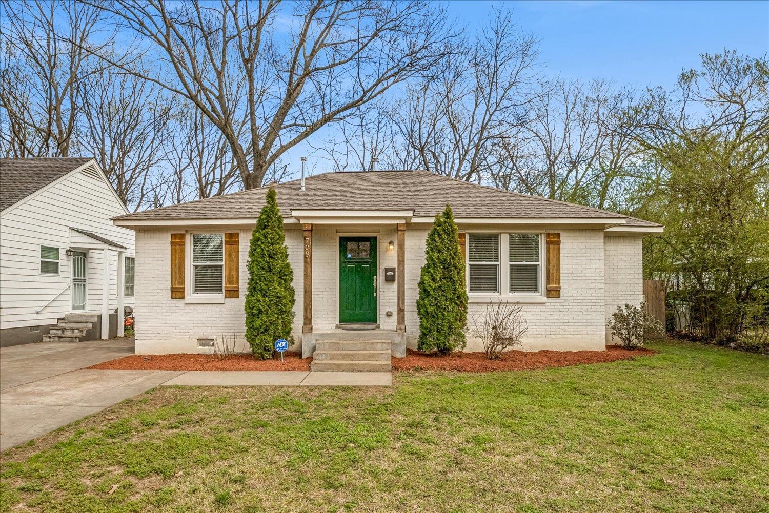 a front view of house with yard and green space
