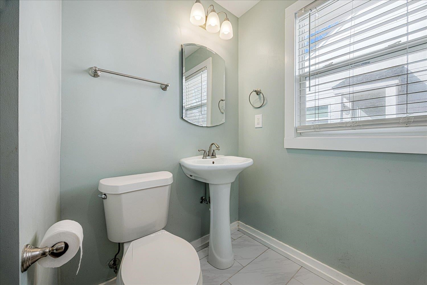 708 Loeb Street Memphis, TN 38111 - Photo 12 of 19 a bathroom with a toilet a sink and mirror