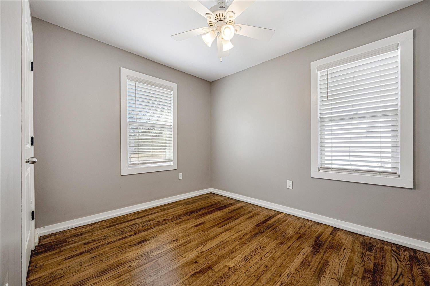 708 Loeb Street Memphis, TN 38111 - Photo 13 of 19 a view of an empty room with wooden floor and a window