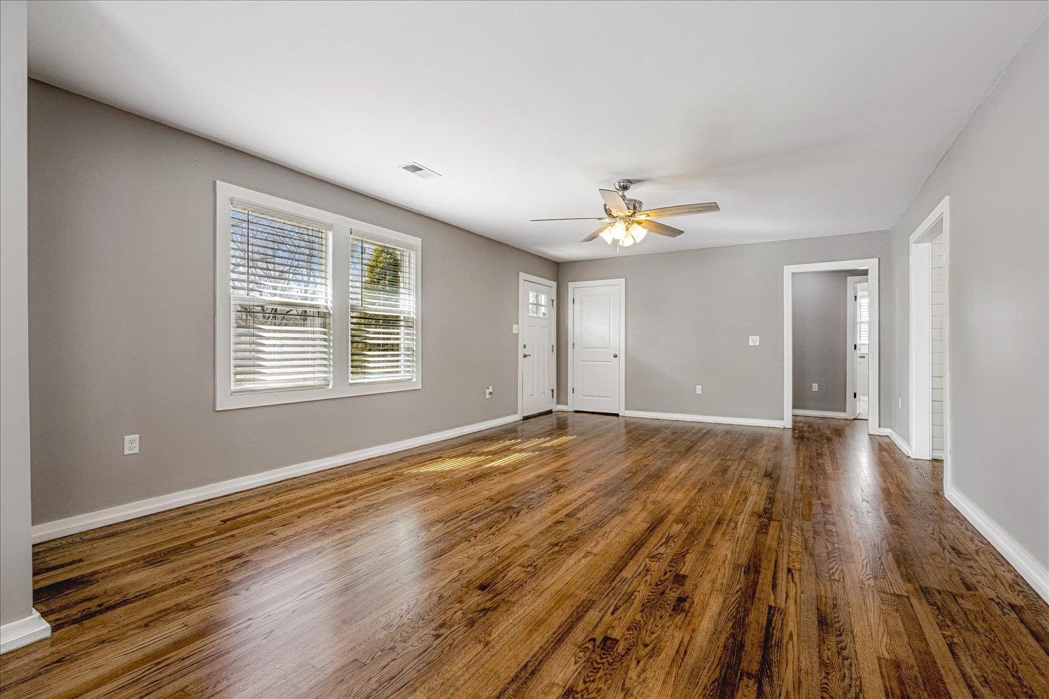 708 Loeb Street Memphis, TN 38111 - Photo 3 of 19 a view of an empty room with wooden floor and a window
