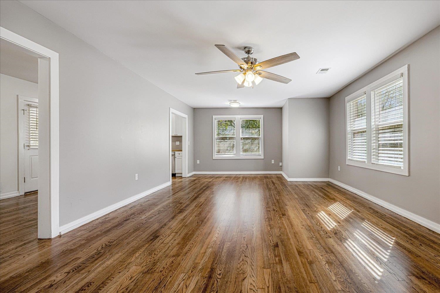 708 Loeb Street Memphis, TN 38111 - Photo 4 of 19 an empty room with wooden floor windows and fan