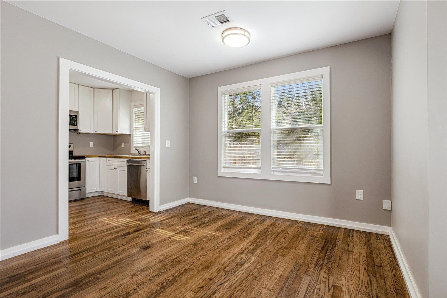708 Loeb Street Memphis, TN 38111 - Photo 5 of 19 a view of a kitchen with a stove cabinets and wooden floor