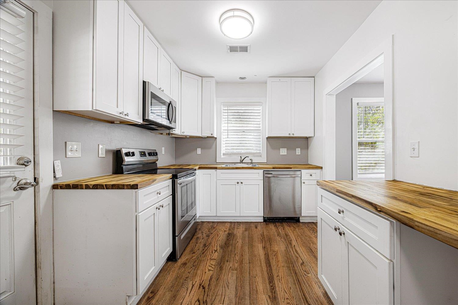 708 Loeb Street Memphis, TN 38111 - Photo 6 of 19 a kitchen with granite countertop a sink cabinets stainless steel appliances and a window