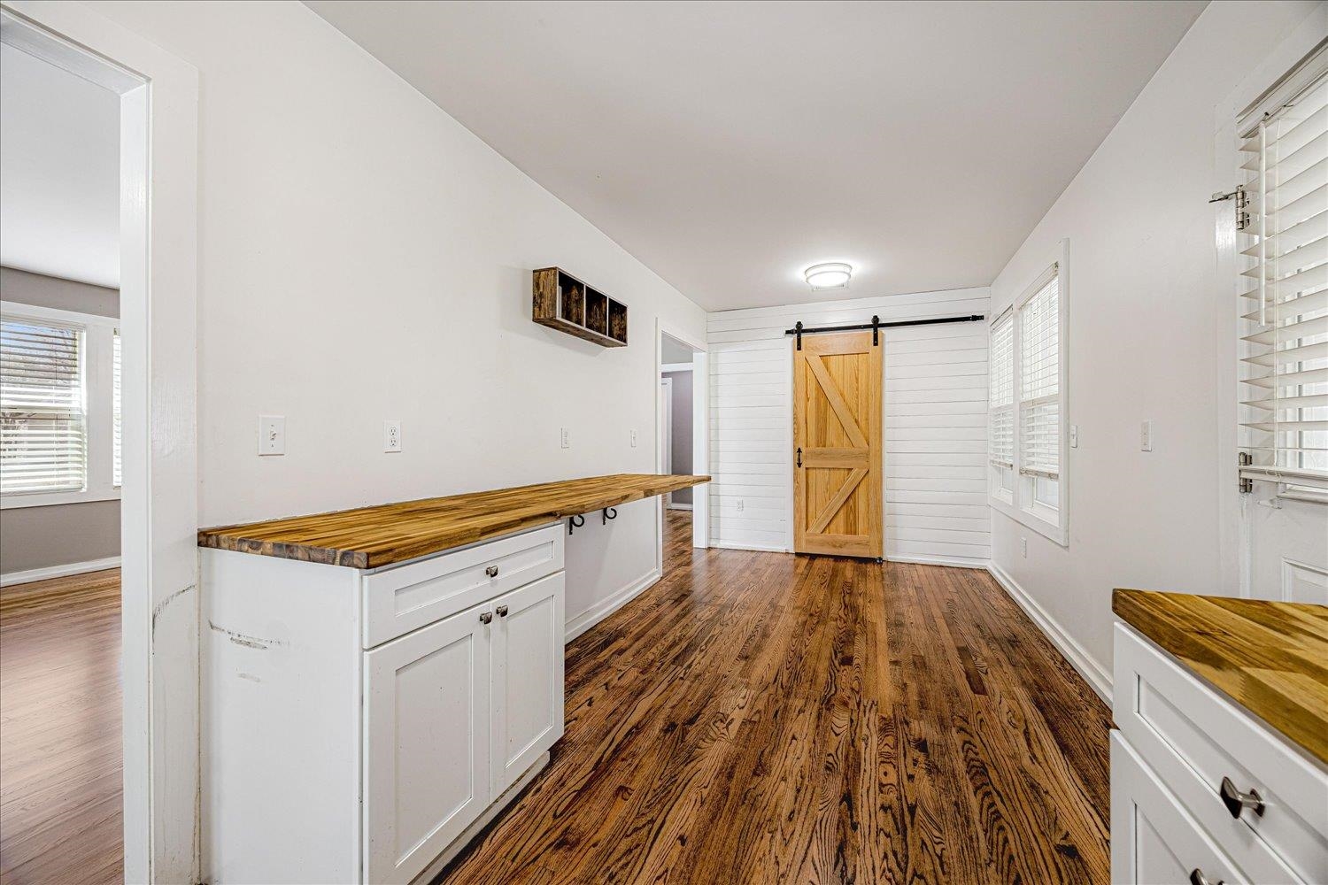 708 Loeb Street Memphis, TN 38111 - Photo 7 of 19 a kitchen with granite countertop white cabinets and wooden floor