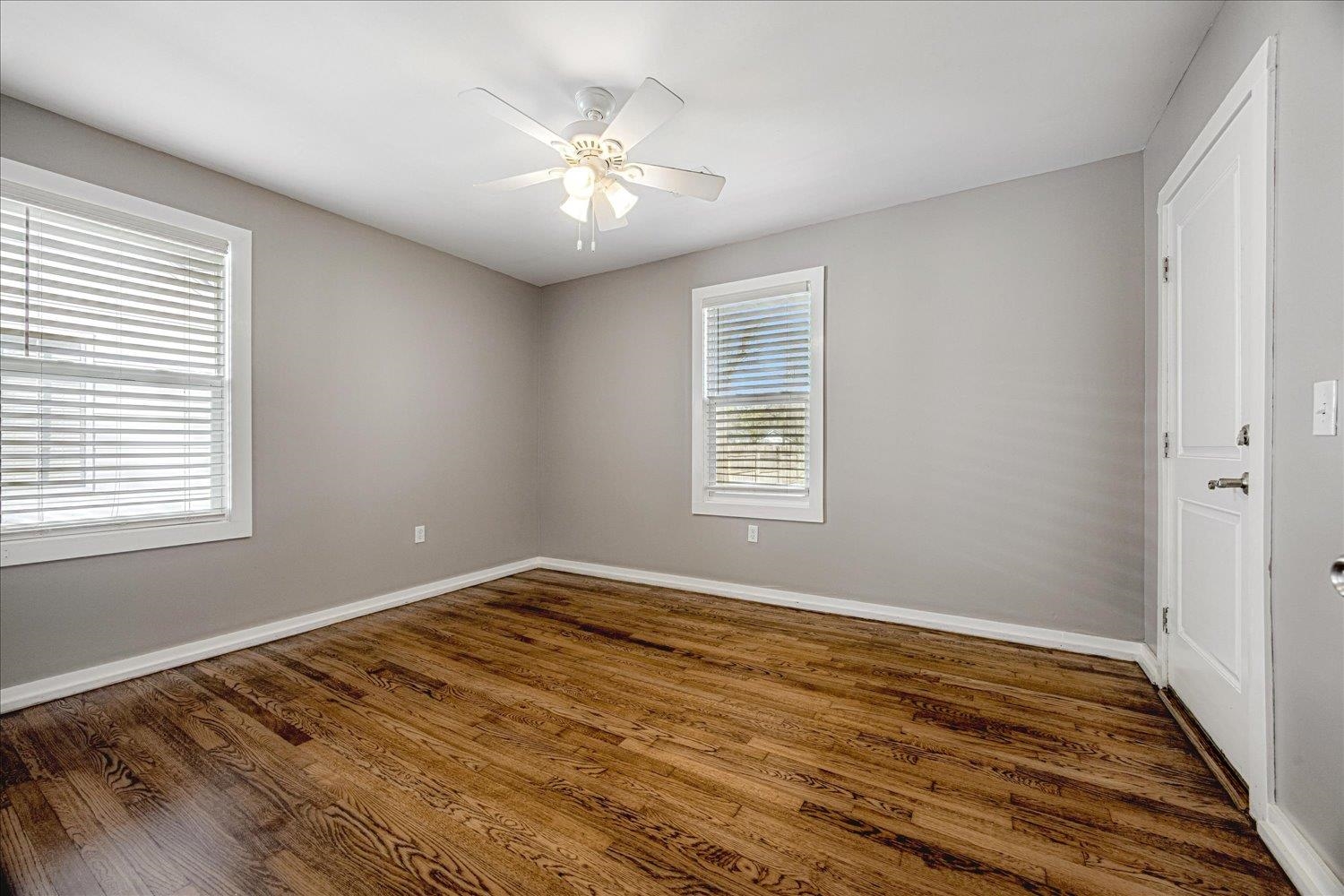708 Loeb Street Memphis, TN 38111 - Photo 9 of 19 a view of an empty room with wooden floor and a window
