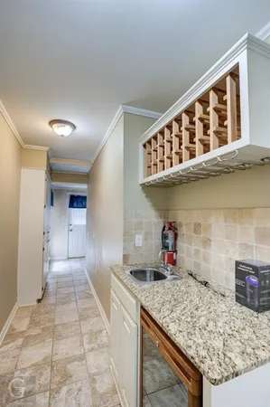 a kitchen with a sink a counter and cabinets