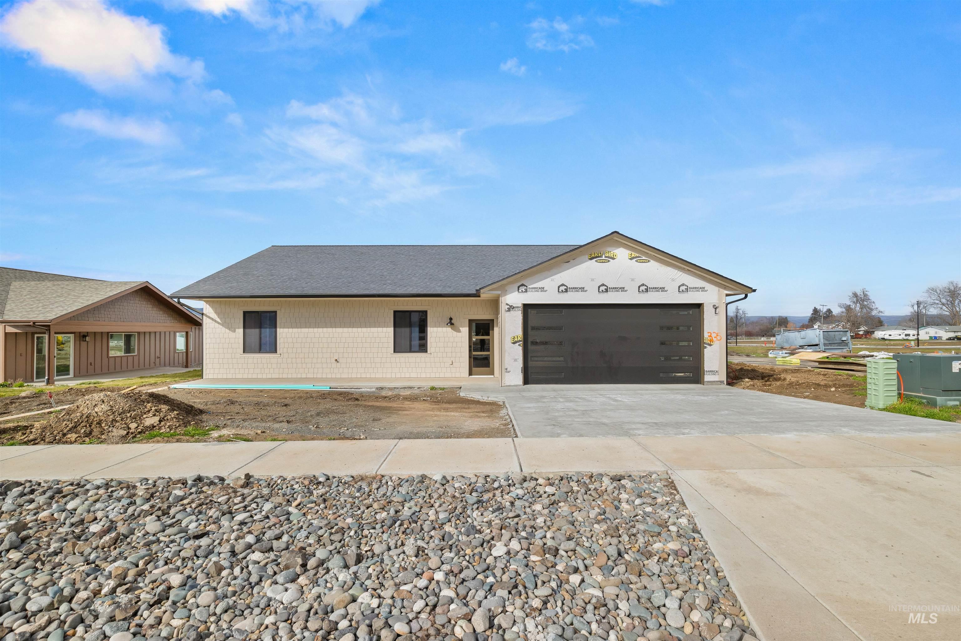 335 Warner Avenue Lewiston, ID 83501 - Photo 5 of 43 View of front of house with concrete driveway, an attached garage, and roof with shingles