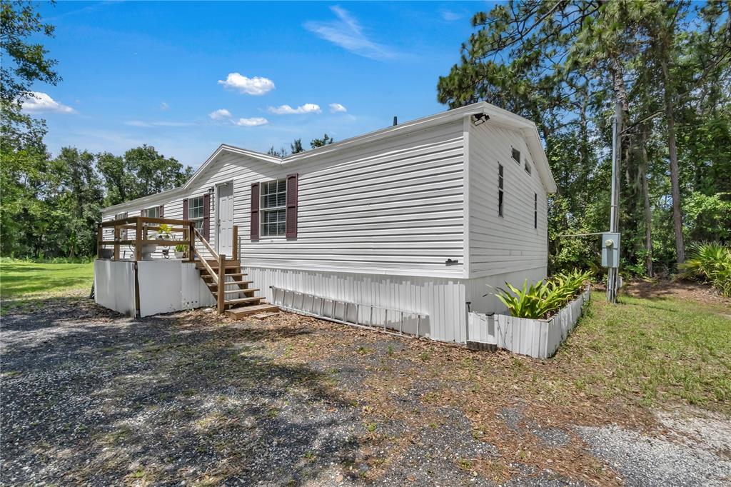 4310 Pine Tree Drive St. Cloud, FL 34772 - Photo 1 of 1 a view of a house with a yard and sitting area